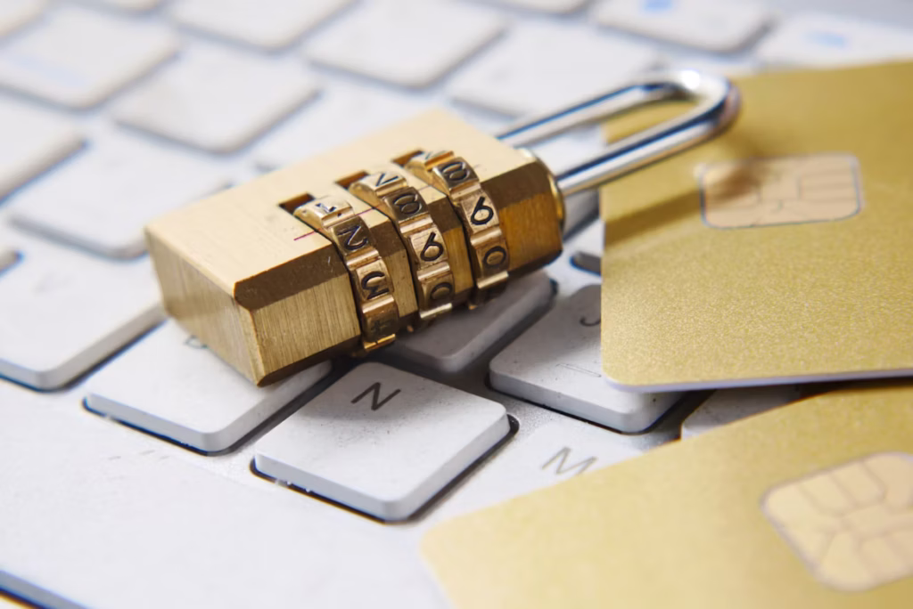Combination padlock resting on white computer keyboard.